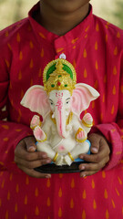 Indian little boy with lord ganesha , Celebrating Ganesh Festival