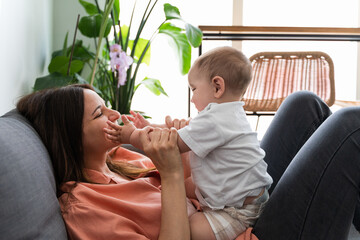 Close up shot of a mother playing with her baby son