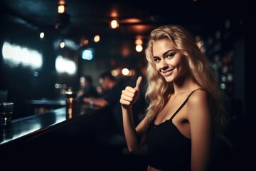 shot of an attractive young woman giving the thumbs up at a club