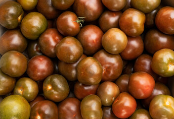 Tomatoes are dark red colors. Top view of a tray with tomatoes farmers market.