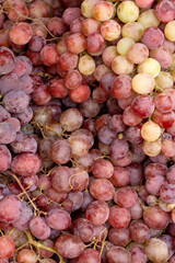 Clusters of blue grapes. Top view of a tray with grapes at a farmer's market.