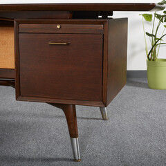 Dark walnut vintage floating top desk. Danish modern furniture. Close-up detail product photograph.