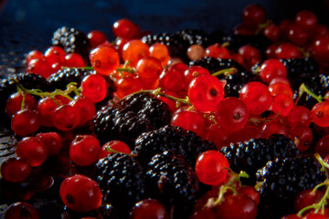 Delight in the vibrant harmony of luscious red currants and plump blackberries, a symphony of taste and beauty.