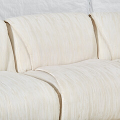 Vintage 1980s white sectional sofa. Textured upholstery furniture. Close-up photograph.
