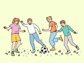 Happy children play football, running on sunny lawn and kicking football ball. Cheerful boys and girls enjoy summer holidays participating in soccer tournament for elementary school students