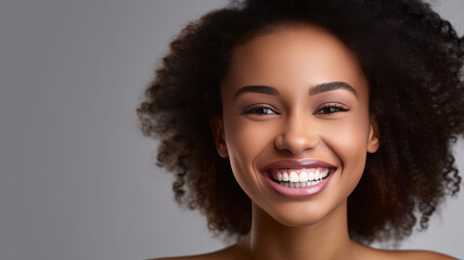 A beautiful young african american model woman smiling with clean teeth isolated.