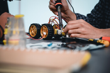 Engineer Asian Students Assembling Robotics Kits. Learning Mechanical Control, Robotics combines computer, electrical, mechanical, and sensing. Empowering Engineers and Development Concept.