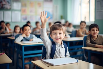Child raises hand to answer in the classroom. Back To School concept.