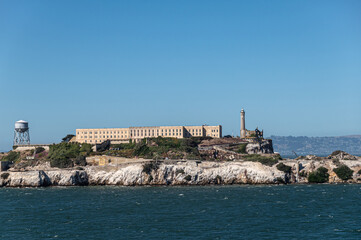 San Francisco, CA, USA - July 13, 2023: West shore of Alcatraz Island showing the main building,...