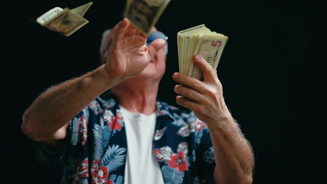 Excited senior man throwing dollar bills in the air, lottery winner, money rain