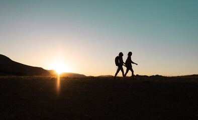 Fototapeta na wymiar two people walk along a mountain range