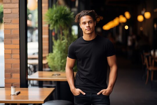 A striking portrait showcasing a male model in a black Bella Canvas t-shirt. A visual of a young gentleman sporting a black shirt, ideal for mockup projects. Utilize the provided template.