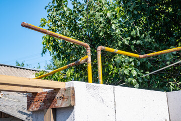 Gas yellow pipes at a construction site. Laying aerated concrete blocks. Construction of aerated concrete blocks, bricks. Home construction