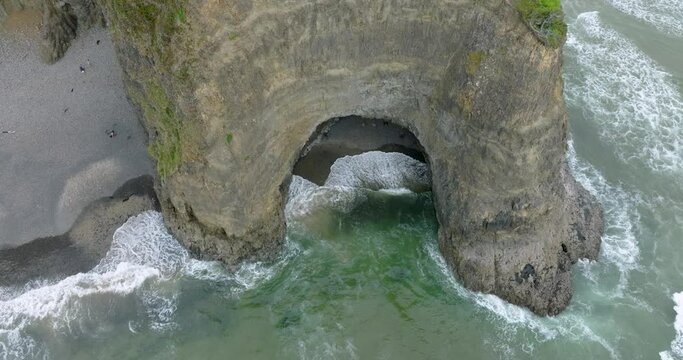 Coastal drama unveiled by drone in the mist.