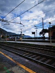 Fototapeta na wymiar Photo of a train station with a train on the tracks