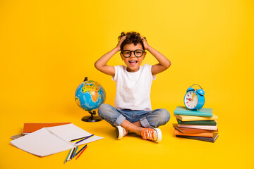 Full length photo of excited funky little boy dressed white t-shirt studying hands arms head isolated yellow color background