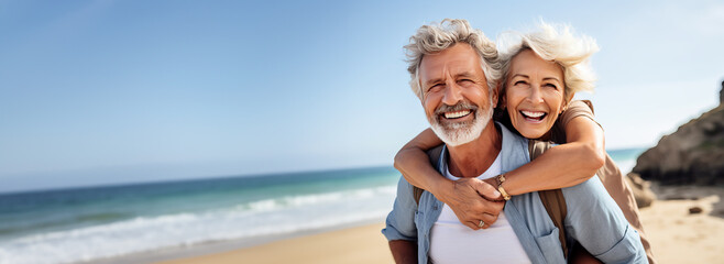 Happy senior couple on a tropical beach in the summer, woman is piggybacking on her husband. Concept of retirement and traveling when you are mature. Shallow field of view with copy space.  - obrazy, fototapety, plakaty