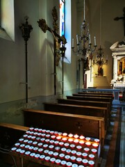 Photo of a beautiful church interior filled with rows of wooden pews