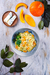 Traditional Italian risotto with Hokkaido pumpkin and gorgonzola soft cheese served as top view in a Nordic design bowl