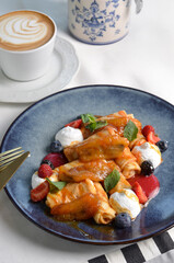 Crepes with Fresh Berries, Caramelized Bananas and Toppings, Thin Pancakes on a Plate
