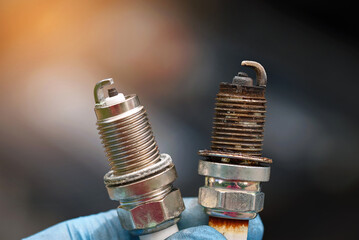 Spark plugs compare, new and old copper spark plugs. Spark plugs with worn electrodes and new one....