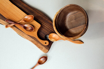 Wooden kitchen utensils, boards, plates and spoons. Set of kitchen utensils made of wood. Eco-friendly utensils. Top view