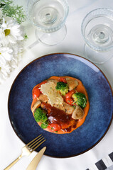 Grilled Chicken Fillet with Vegetables and Sauce, Roasted Chicken Breast on a Plate on Bright Background