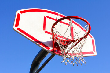 Red basketball basket on a blue sky background, side view, sports equipment