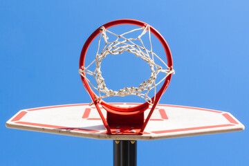 Basketball basket on the sky background, bottom view, colorful minimalism, sports background