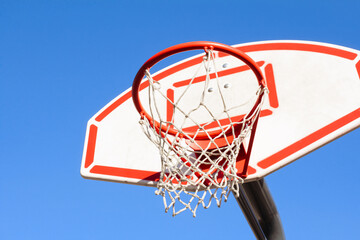 Red basketball basket against the sky, sports equipment, side view on the right