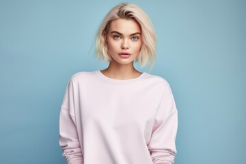 Fototapeta premium Portrait of a Fictional Model Wearing a Large Oversized Plain Sweatshirt Isolated on a Colored Blank Background. Generative AI.