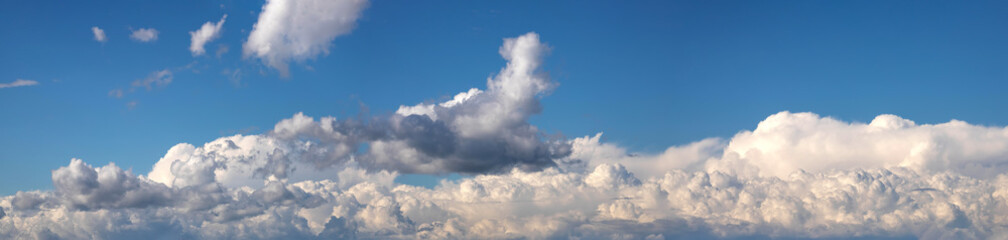 Panorama the white cumulus clouds on blue sky in the sunny day.