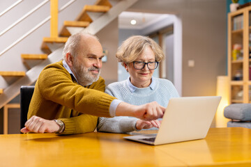 Smiling Grandparents Learning new Technologies