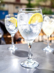 A Gin Tonic cocktail on a table of a bar terrace.