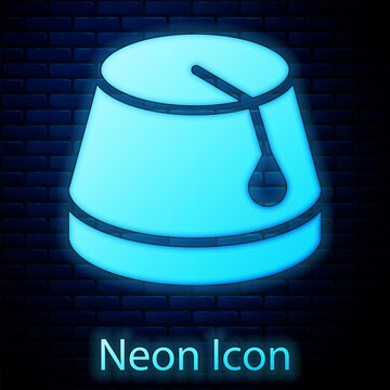 Glowing neon Turkish hat icon isolated on brick wall background. Vector