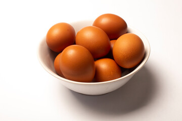 photo of eggs in a bowl on a white background