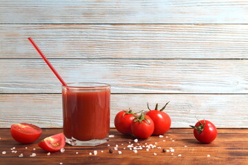 There is one glass of tomato juice on the table.