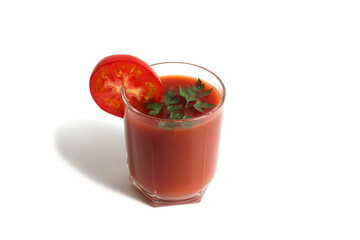 On a white background is a glass of tomato juice with tomatoes and herbs.