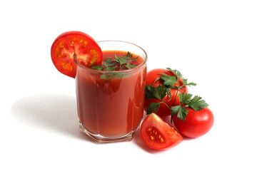 On a white background is a glass of tomato juice with tomatoes and herbs.