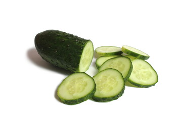Many pieces of sliced cucumber lie on a white background.