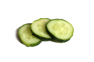 Three pieces of sliced cucumber lie on a white background.