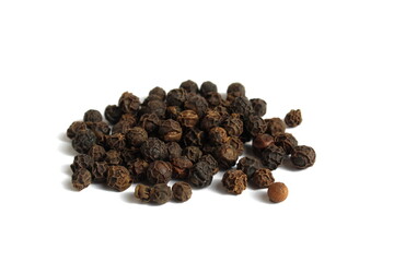 A bunch of black peppers with polka dots lie on a black background.