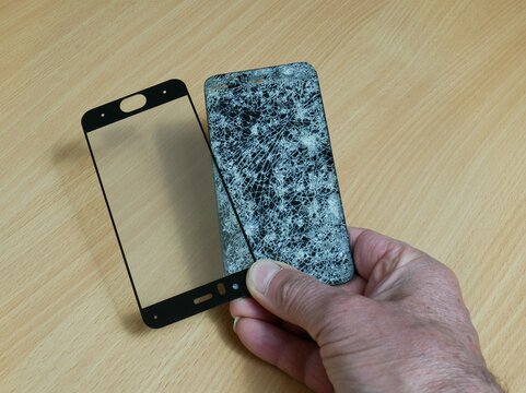 In his right hand is a broken phone and a protective glass for it.