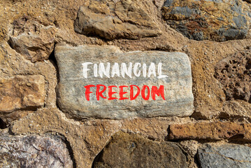Financial freedom symbol. Concept words Financial freedom on beautiful big stone. Beautiful stone wall background. Business financial freedom concept. Copy space.