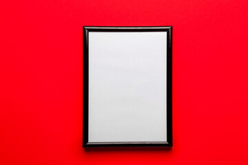 Blank picture frame on red background