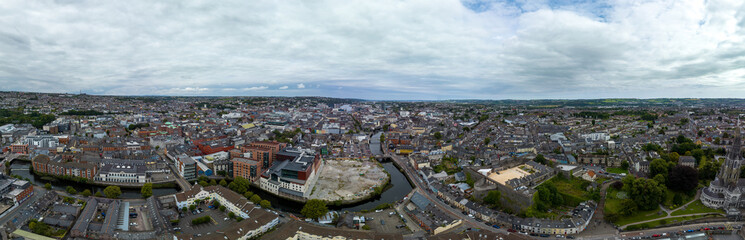 Fototapeta na wymiar Aerial panorama of Cork in Southern Ireland with St Colman's cathedral, Elizabeth Fort, Bishop Lucey park, River Lee, Saint Fin Barre's Cathedral