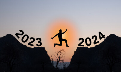 Person jumping from 2023 to 2024 happy new year concept