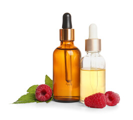 Bottles of cosmetic raspberry oil on white background