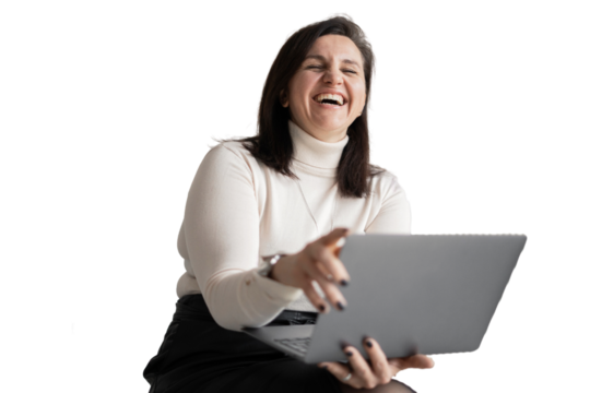 Using a laptop computer, the designer young woman laughs and looks away. An office employee, a young entrepreneur in the office.