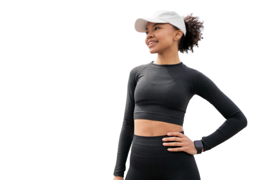 Athletic young female coach in a cap. The athlete portrait smiles and shows confidence. The fitness suit is tight and comfortable.